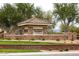 Stone entrance to Ironwood Crossing by Fulton Homes with manicured landscaping and greenery surrounding the sign at 690 W Mangrove Rd, Queen Creek, AZ 85140