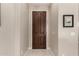 Warm and welcoming entryway featuring a dark wooden door and neutral walls at 690 W Mangrove Rd, Queen Creek, AZ 85140