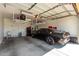 Spacious garage with storage racks and a sleek black sports car parked inside at 690 W Mangrove Rd, Queen Creek, AZ 85140