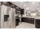 Spacious kitchen showcasing stainless steel appliances, dark cabinetry, and an open layout at 690 W Mangrove Rd, Queen Creek, AZ 85140