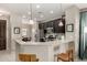 Modern kitchen with granite countertops, stainless steel appliances, and dark cabinetry at 690 W Mangrove Rd, Queen Creek, AZ 85140