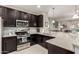 Well-equipped kitchen featuring stainless steel appliances, a breakfast bar, and tile backsplash at 690 W Mangrove Rd, Queen Creek, AZ 85140