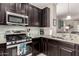 Updated kitchen with stainless steel oven, microwave, and granite countertops at 690 W Mangrove Rd, Queen Creek, AZ 85140