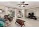 Comfortable living room with tile flooring, a ceiling fan, and sliding glass doors at 690 W Mangrove Rd, Queen Creek, AZ 85140