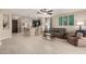Open-concept living room flows into the kitchen, featuring bar seating and tile floors at 690 W Mangrove Rd, Queen Creek, AZ 85140