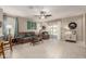 Inviting living room with tile floors, neutral paint, comfortable furniture, and access to the backyard at 690 W Mangrove Rd, Queen Creek, AZ 85140