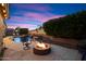 Backyard featuring a pool, a fire pit, an outdoor kitchen, patio seating, a waterfall feature, and more at 7238 W El Cortez Pl, Peoria, AZ 85383