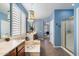 Bright primary bathroom featuring dual sinks, a soaking tub, a separate shower and a decorative hanging light fixture at 7238 W El Cortez Pl, Peoria, AZ 85383