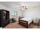 Neutral bedroom with a ceiling fan, a window, and a bedframe set on carpeting and furniture and decor at 7238 W El Cortez Pl, Peoria, AZ 85383