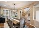 Elegant dining room with a large table, stylish chandelier, and natural light from the windows at 7238 W El Cortez Pl, Peoria, AZ 85383