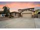 Attractive home exterior with a wide driveway, mature landscaping, and a spacious two-car garage at 7238 W El Cortez Pl, Peoria, AZ 85383