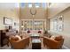 Bright and open living room with a high ceiling, plantation shutters, and comfortable seating at 7238 W El Cortez Pl, Peoria, AZ 85383