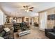 Open floorplan features a spacious living room connected to the kitchen and dining area with neutral paint at 7238 W El Cortez Pl, Peoria, AZ 85383