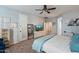 Bright main bedroom with plantation shutters, neutral paint, and a TV at 7238 W El Cortez Pl, Peoria, AZ 85383