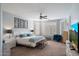Airy main bedroom features neutral paint, ceiling fan, plantation shutters, and comfortable furniture at 7238 W El Cortez Pl, Peoria, AZ 85383