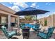 Inviting backyard with a sparkling pool, fire pit, and comfortable seating, perfect for outdoor entertaining at 7554 E Globemallow Ln, Gold Canyon, AZ 85118