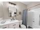 Well-lit bathroom with a vanity, a toilet, a shower with curtain, and modern fixtures at 7554 E Globemallow Ln, Gold Canyon, AZ 85118