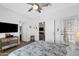 Bedroom with a bed, dresser with TV, and access to other rooms, providing a seamless flow throughout the home at 7554 E Globemallow Ln, Gold Canyon, AZ 85118