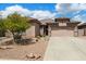 Charming single-story home showcasing a low-maintenance desert landscape and two-car garage in a sunny neighborhood at 7554 E Globemallow Ln, Gold Canyon, AZ 85118
