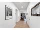 Bright hallway featuring neutral tile flooring, access to multiple rooms, and stylish decor at 7554 E Globemallow Ln, Gold Canyon, AZ 85118