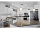 Well-appointed kitchen featuring granite countertops, ample white cabinetry, and modern stainless steel appliances at 7554 E Globemallow Ln, Gold Canyon, AZ 85118