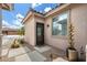 Side entrance boasting desert landscaping, a security door, and a unique water feature enhancing the curb appeal at 7554 E Globemallow Ln, Gold Canyon, AZ 85118