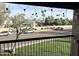 Apartment balcony view of a street, cars, trees, and blue skies at 8260 E Arabian Trl # 275, Scottsdale, AZ 85258