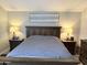 Warm and inviting bedroom featuring wood furniture and soft, neutral tones with lamps on either side of the bed at 8260 E Arabian Trl # 275, Scottsdale, AZ 85258