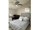 Cozy bedroom featuring a ceiling fan, grey walls, and a comfy bed with a decorative headboard at 8260 E Arabian Trl # 275, Scottsdale, AZ 85258