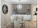 Dining area with glass table and chairs, modern light fixture and wine rack at 8260 E Arabian Trl # 275, Scottsdale, AZ 85258