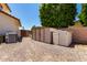 Backyard featuring sheds, an AC unit, and a fenced gate leading to the rest of the yard at 844 W Sherri Dr, Gilbert, AZ 85233