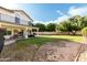 Expansive backyard with covered patio, balcony, lush lawn area, and mature trees, perfect for outdoor living at 844 W Sherri Dr, Gilbert, AZ 85233