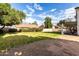 Expansive backyard with lush green lawn and mature trees, offering a serene outdoor space at 844 W Sherri Dr, Gilbert, AZ 85233