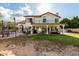 Large backyard with a pool area, covered patio, a balcony, green grass and mature trees at 844 W Sherri Dr, Gilbert, AZ 85233