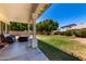 Enjoy a spacious backyard with a covered patio, green lawn, mature trees, and room for outdoor activities at 844 W Sherri Dr, Gilbert, AZ 85233