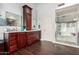 Spacious bathroom featuring wood look tile, double vanity, large mirror and walk-in shower at 844 W Sherri Dr, Gilbert, AZ 85233