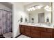 Bathroom with double sink vanity and decorative shower curtain at 844 W Sherri Dr, Gilbert, AZ 85233