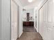 Hallway view leading to spacious bathroom with dark cabinets, bath and walk-in shower at 844 W Sherri Dr, Gilbert, AZ 85233