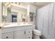 Bathroom featuring white vanity, sink, drawers, toilet, mirror, and shower at 844 W Sherri Dr, Gilbert, AZ 85233