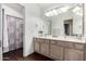 Bathroom featuring dual sinks, wood-look floors, and a shower/tub combination with tiled accents at 844 W Sherri Dr, Gilbert, AZ 85233