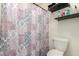 Bathroom featuring a shower with decorative shower curtain, toilet, and shelves at 844 W Sherri Dr, Gilbert, AZ 85233