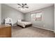 Neutral bedroom with a large window providing natural light, complemented by carpet flooring and closet space at 844 W Sherri Dr, Gilbert, AZ 85233