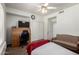 Bedroom featuring a desk, chair, closet, ceiling fan, and neutral tones at 844 W Sherri Dr, Gilbert, AZ 85233