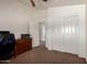 Spacious bedroom featuring brown carpet, closet, doors and a printer at 844 W Sherri Dr, Gilbert, AZ 85233