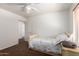 Bedroom featuring brown carpet, baseboard, window, and a decorated bed at 844 W Sherri Dr, Gilbert, AZ 85233