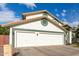 View of the three-car garage of this home with a red tile roof at 844 W Sherri Dr, Gilbert, AZ 85233