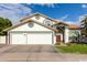 Charming home featuring a three-car garage, red tile roof, and lush green lawn at 844 W Sherri Dr, Gilbert, AZ 85233