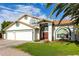 Charming home featuring a three-car garage, red tile roof, and lush green lawn at 844 W Sherri Dr, Gilbert, AZ 85233