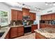 Bright kitchen featuring granite counters, stainless appliances, wood cabinets, and tile floors at 844 W Sherri Dr, Gilbert, AZ 85233