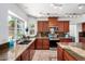 Spacious kitchen featuring granite counters, stainless appliances, wood cabinets, and tile floors at 844 W Sherri Dr, Gilbert, AZ 85233